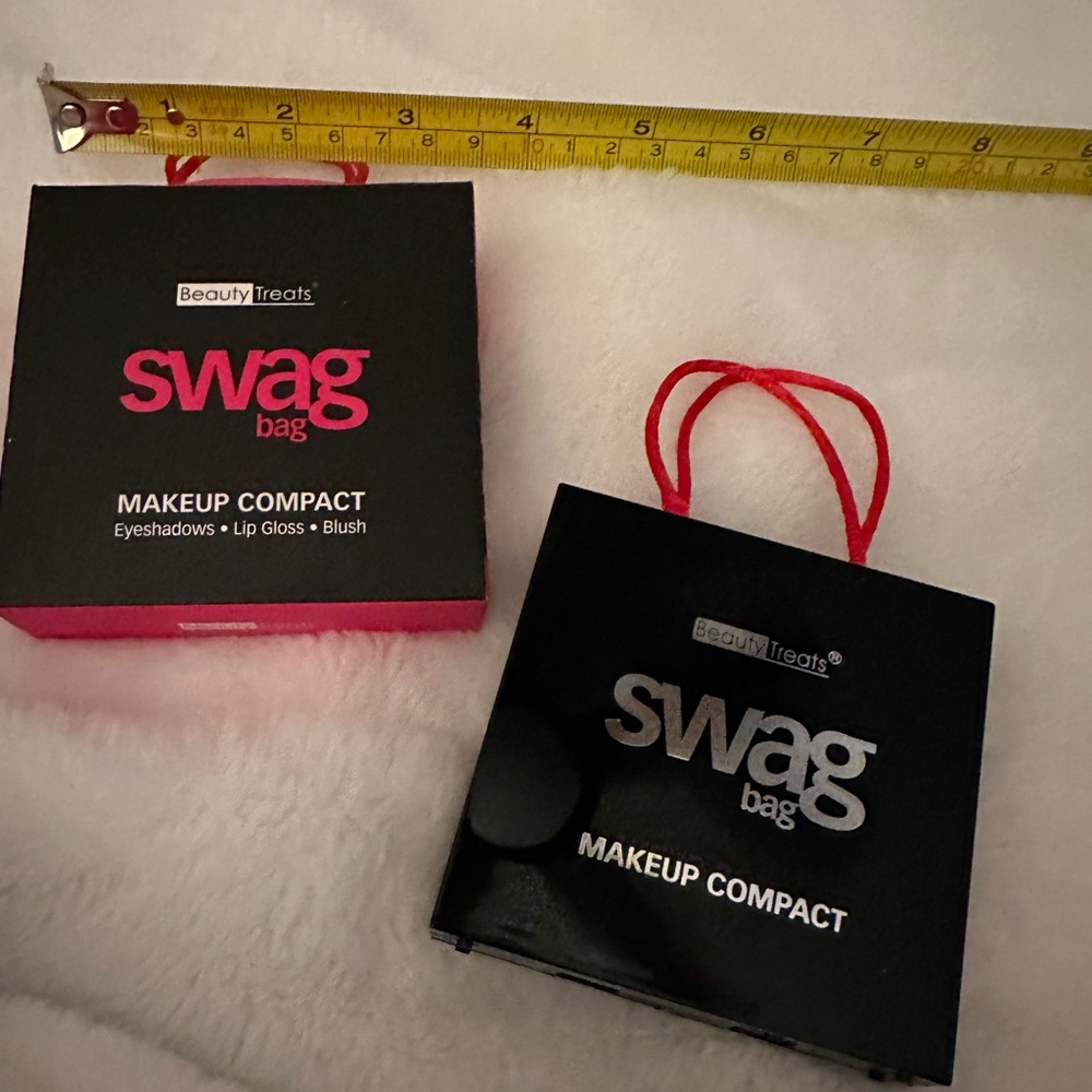 Two swag bag makeup compacts.